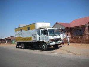 A truck parked next to the road to deliver blankets