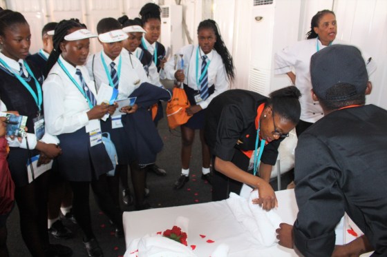 North West Hotel Schools Hospitality students demonstrating to high svhool students how to make a bed professionally for guests.